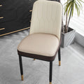Orange leather horseshoe-shaped seat cushion on a wooden chair showing non-slip base.