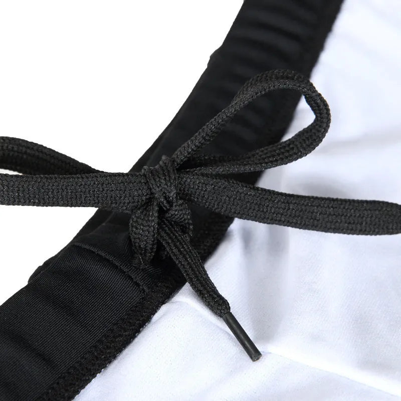 Men's patterned boxer swim trunks in plus sizes with optional swimming cap on a black background.