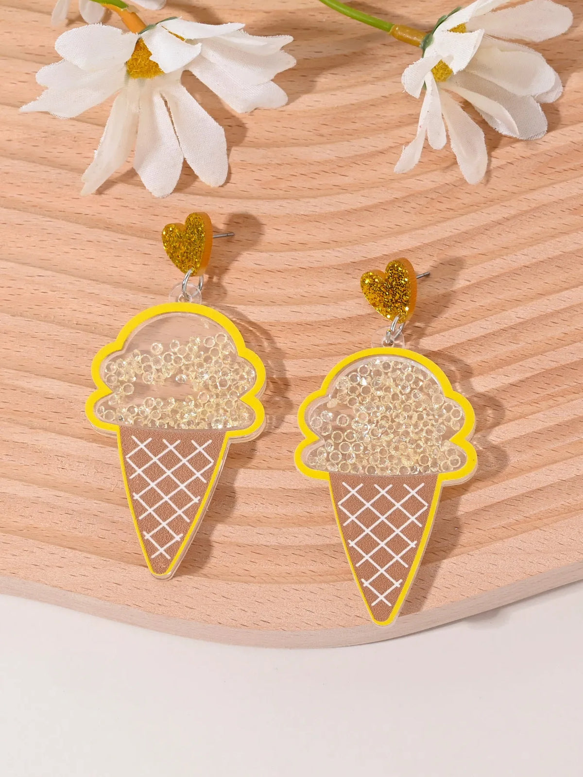 Acrylic drop earrings shaped like a strawberry, cherry, watermelon, pineapple, cake, ice cream, and coconut tree on a white background.