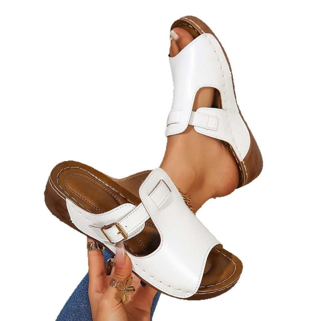 Women's white Roman slipper shoe with elastic magic stick strap and EVA sole.