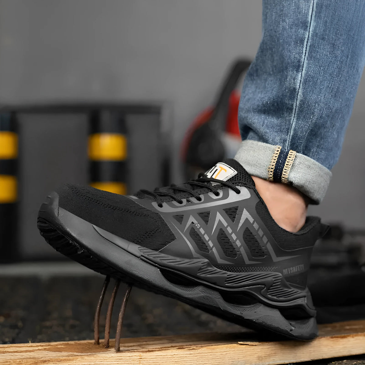 Black lightweight breathable steel toe cap labour protection safety shoes on a white background