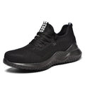 Black work safety shoe with steel toe cap and EVA sole on a grey background