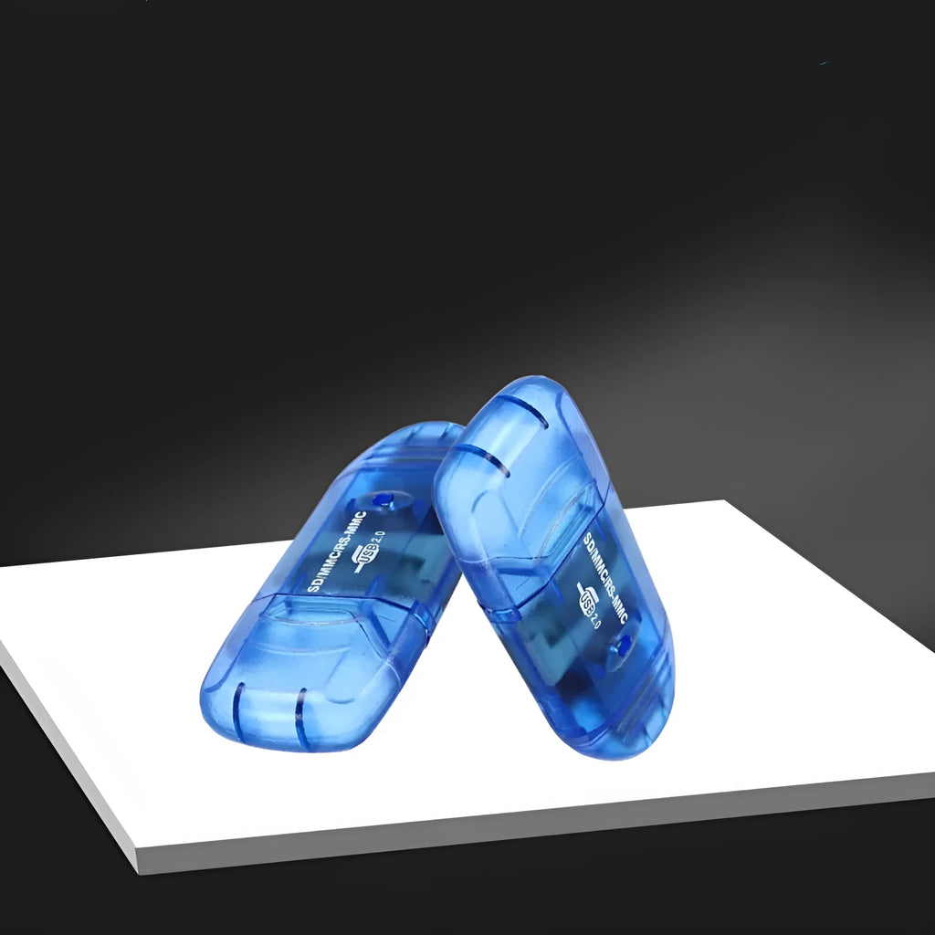 Transparent plastic USB card reader with LED illumination on a desk.