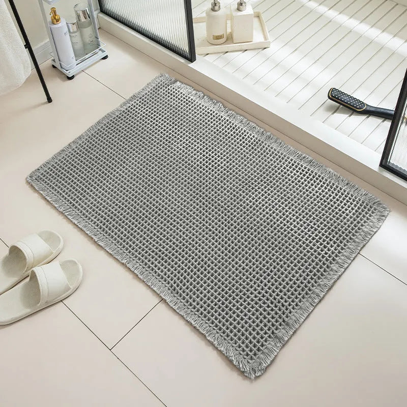 Checkered pattern non-slip absorbent bathroom carpet on a tiled floor.