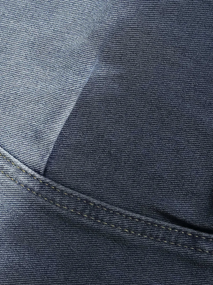 Blue tie-dye gradient washed-out cropped jeans on a model, showing loose fit and mid-waist.
