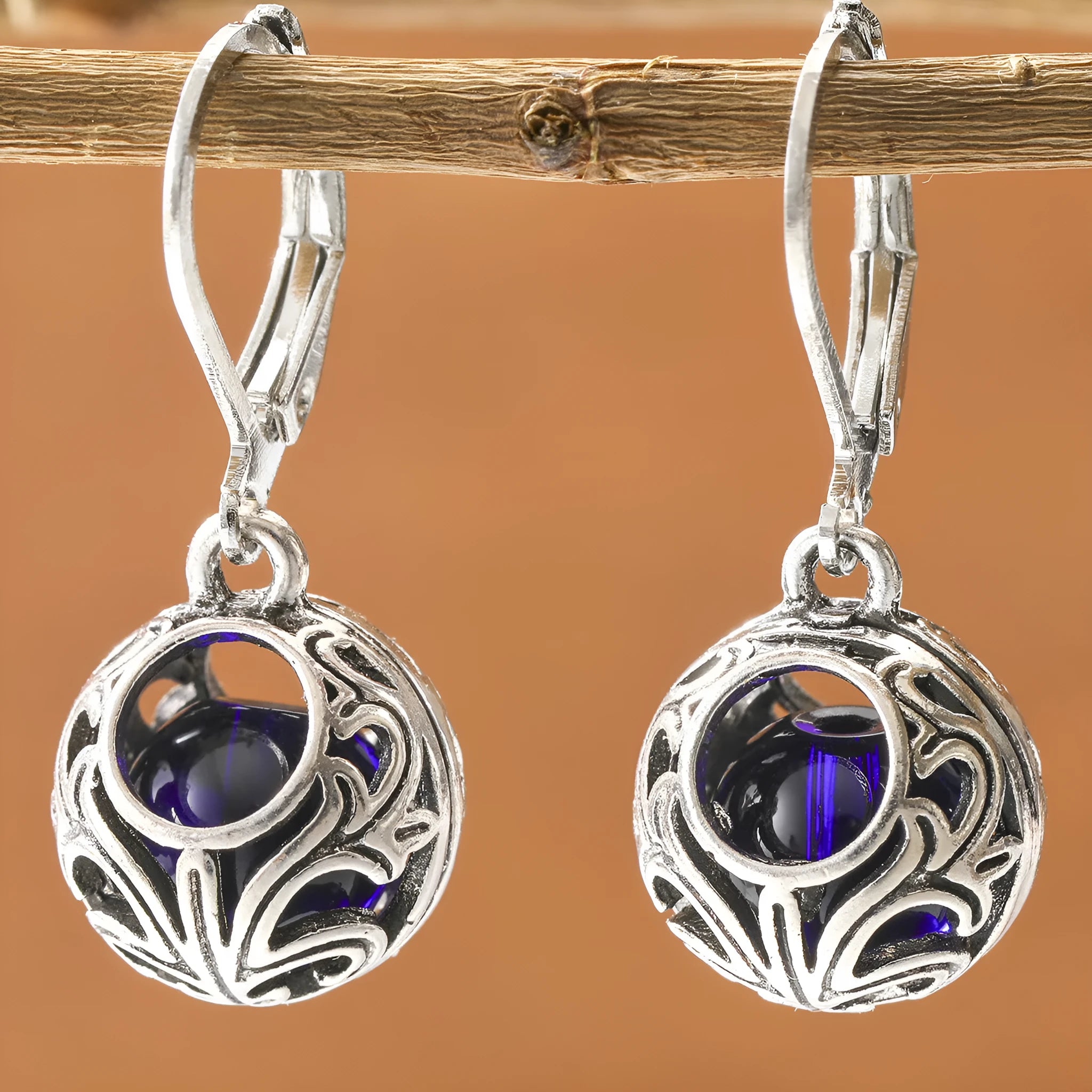 Women's geometric earrings with vintage engraving and hollow blue gemstone pendants in silver colour