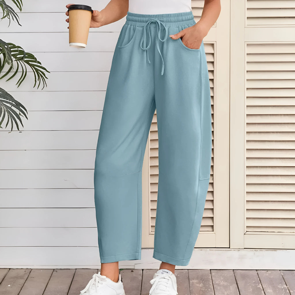 Loose cropped sweatpants with drawstring waist in apricot colour showing side pockets and street fashion styling