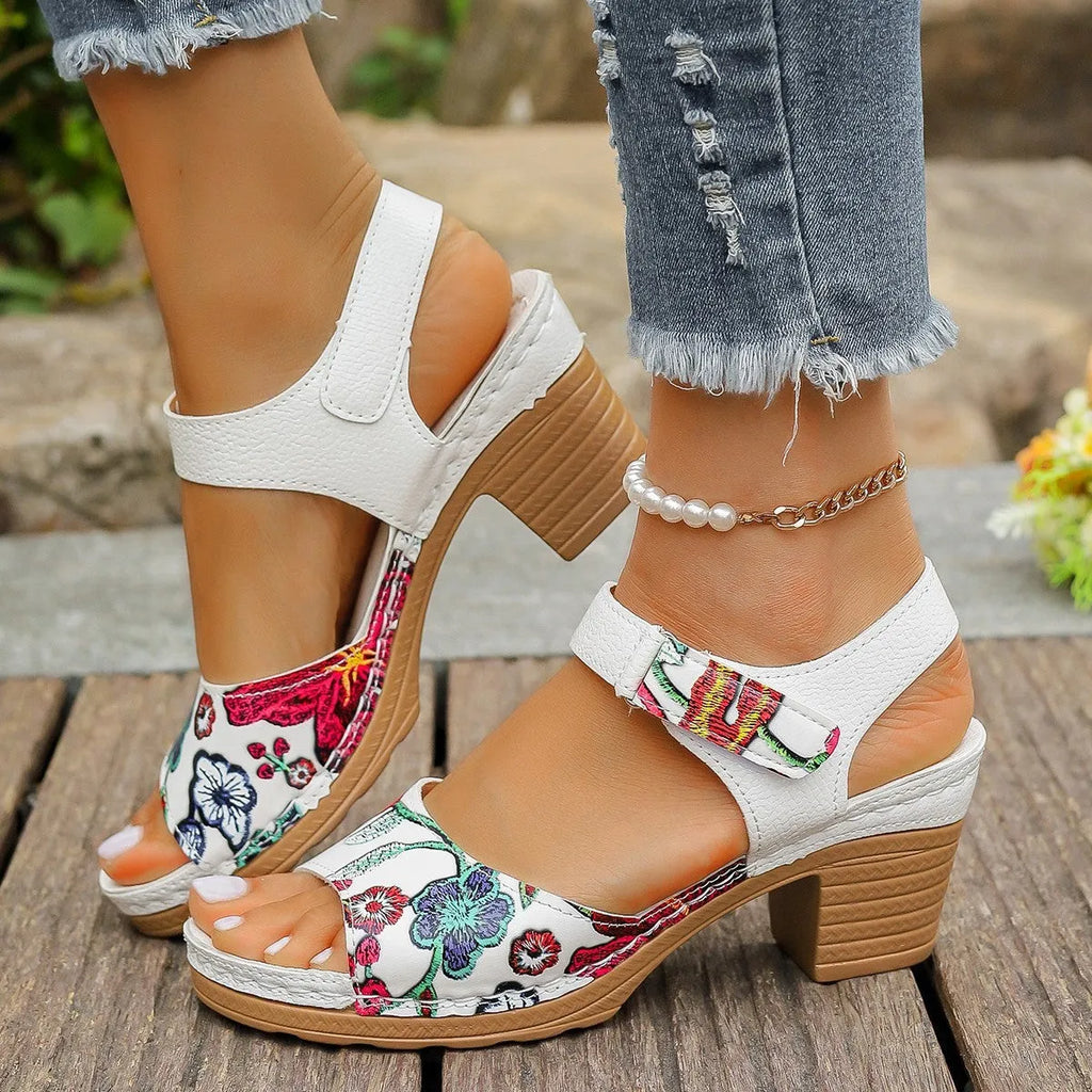 White women's high heel sandals with an adjustable velcro strap buckle fastening.