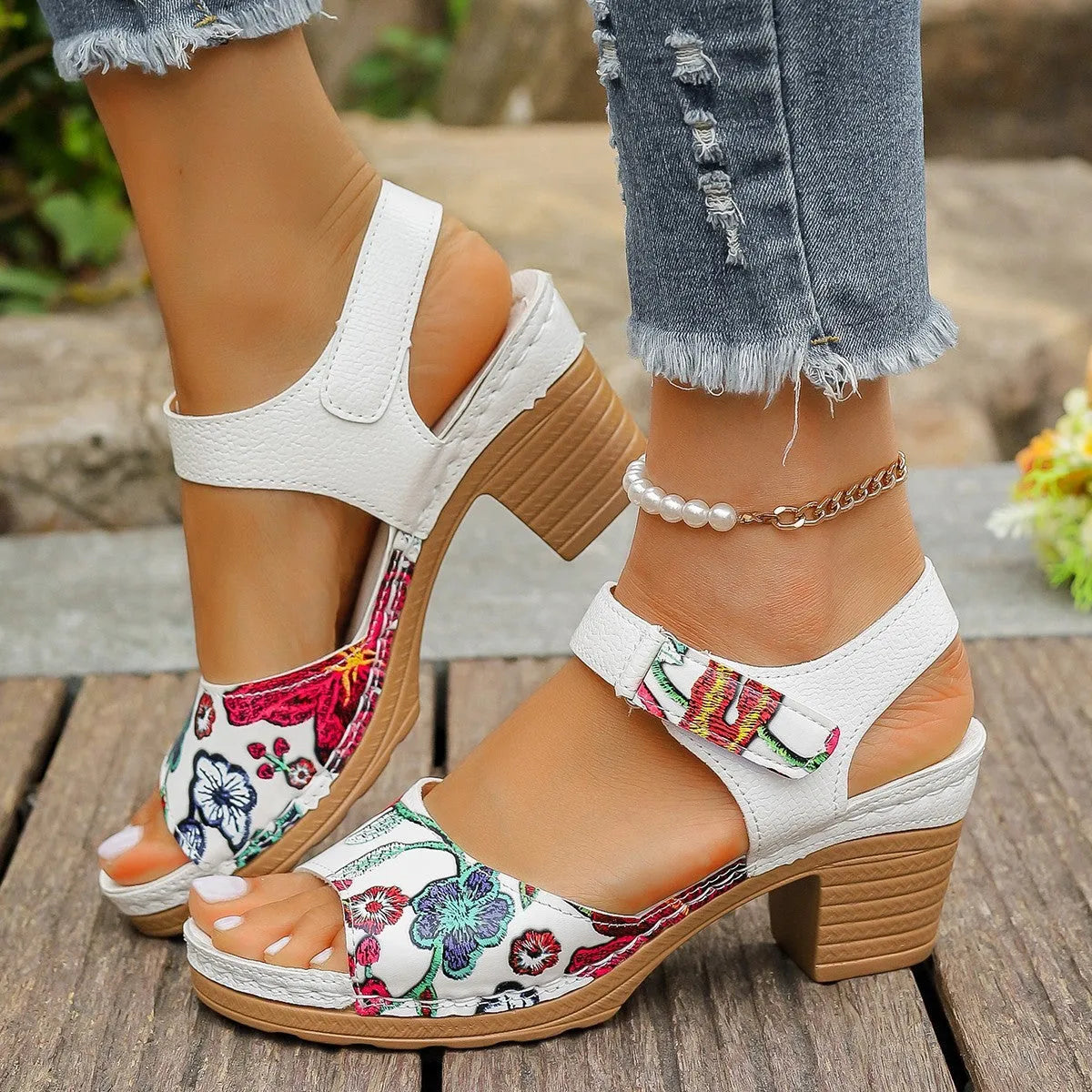White women's high heel sandals with an adjustable velcro strap buckle fastening.