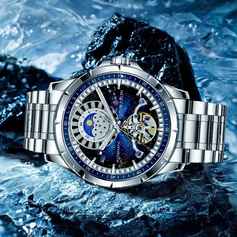 Silver automatic mechanical watch with blue dial and stainless steel bracelet on wrist