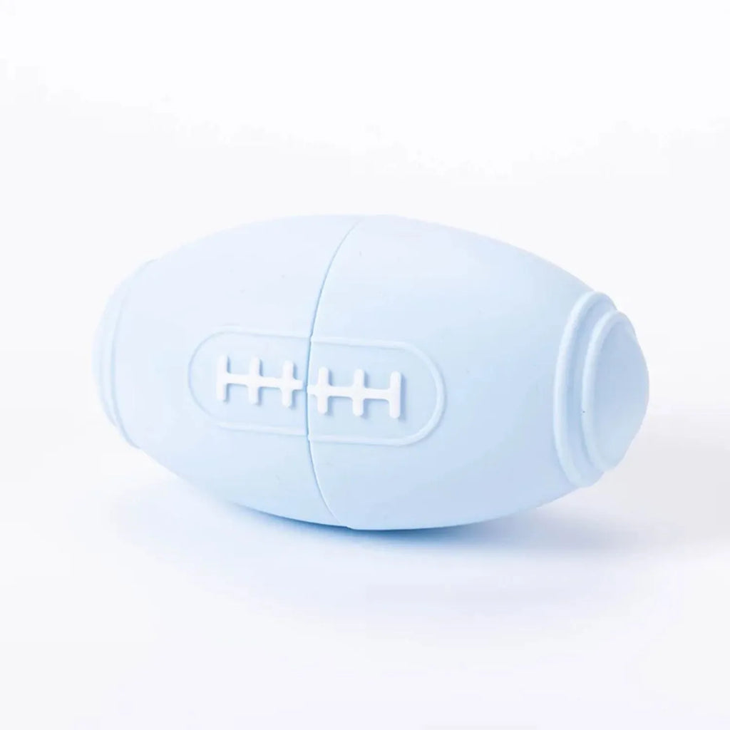 Silicone rugby-shaped dog toy with food leak hole, available in blue, light blue, pink, and purple.