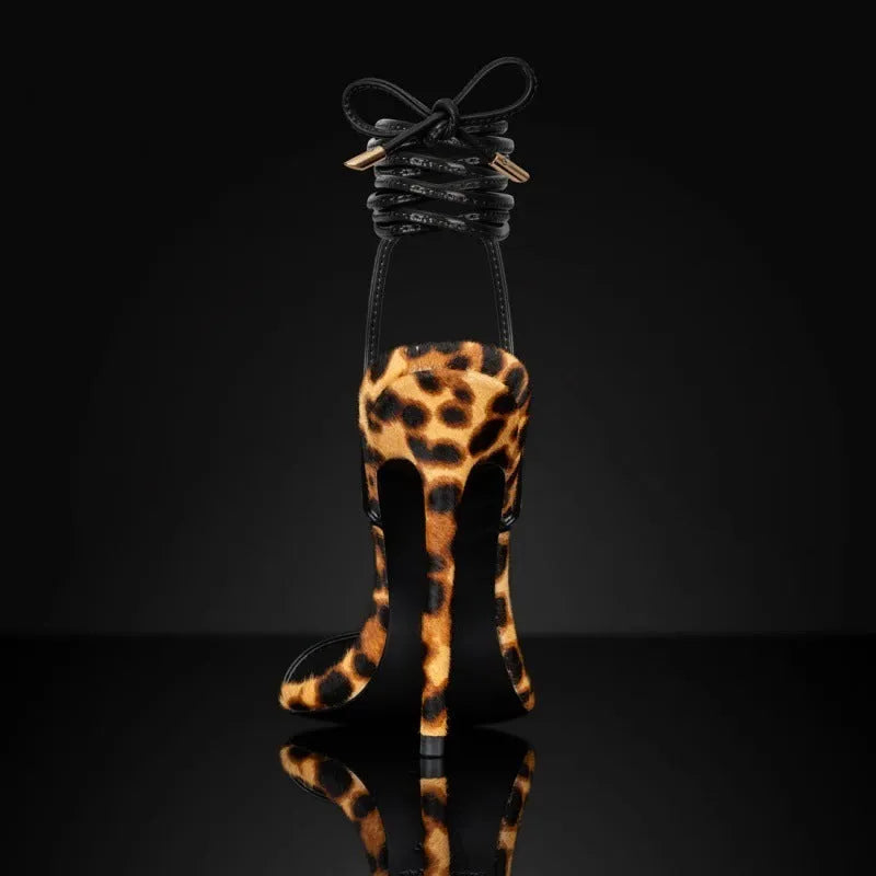 Women's leopard print Roman sandals with pointed toe and lace-up buckle design.