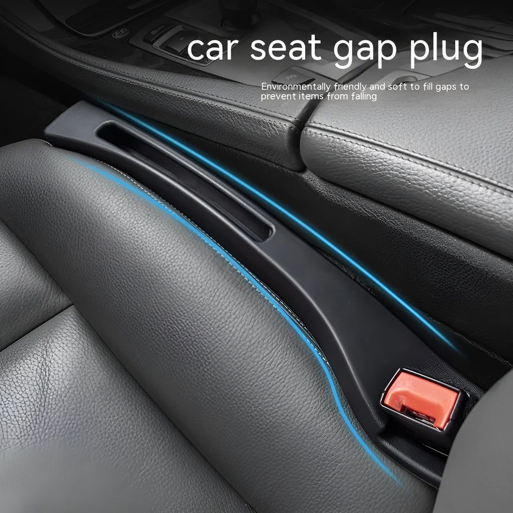 Black plastic car seat gap storage organiser box with a handle, shown inserted between vehicle seats.