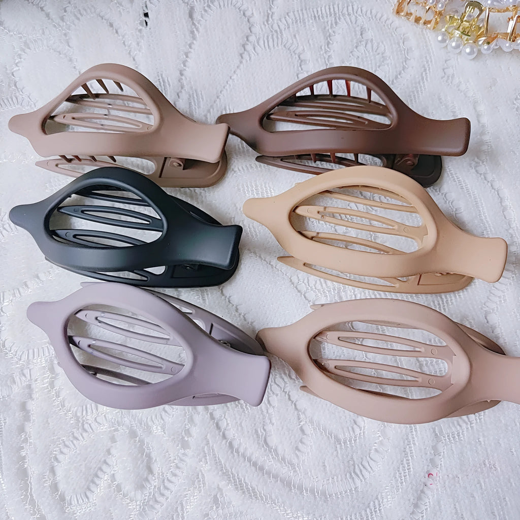 Six rose red and nude plastic hair clips with frosted grips and a quadrilateral shape.