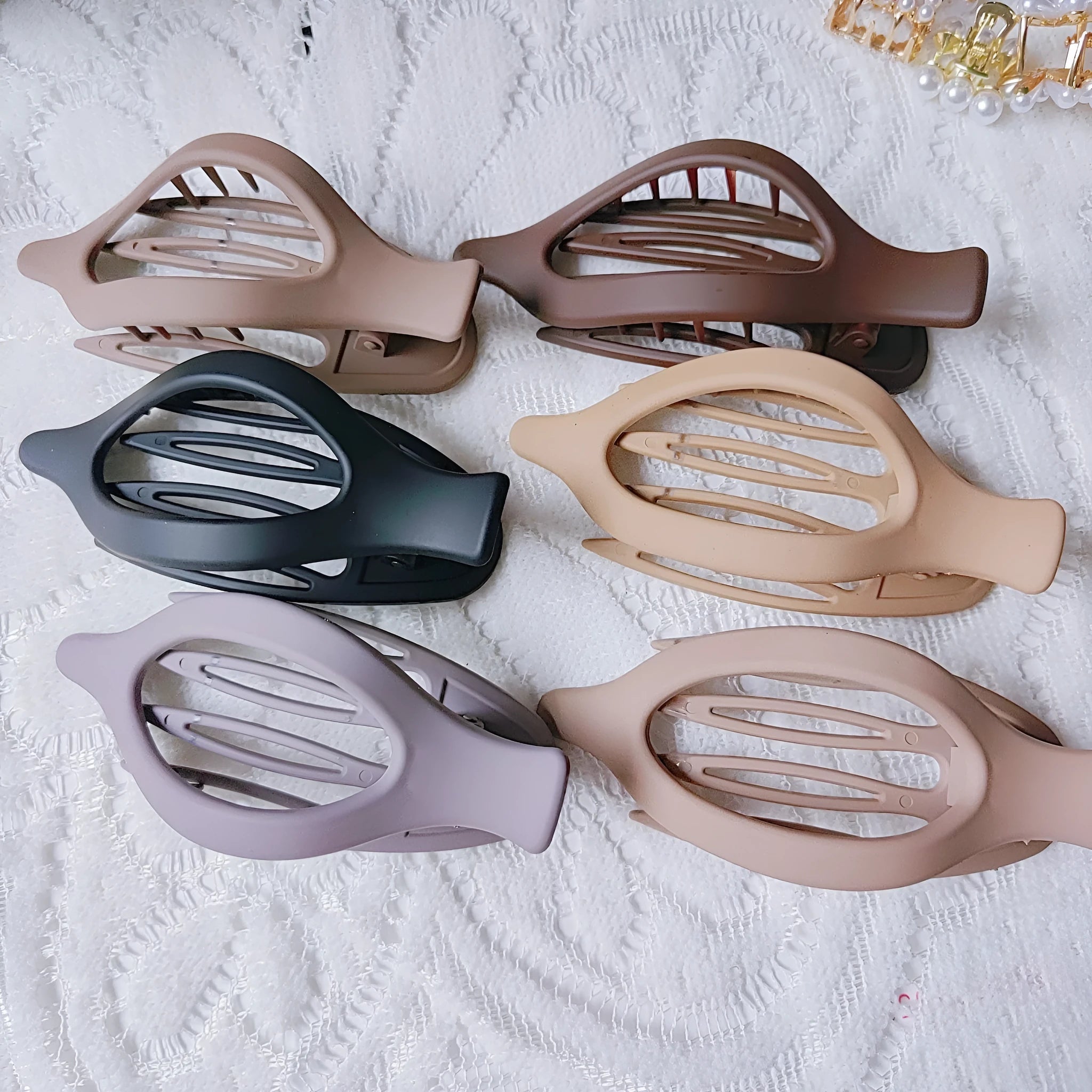 Six rose red and nude plastic hair clips with frosted grips and a quadrilateral shape.
