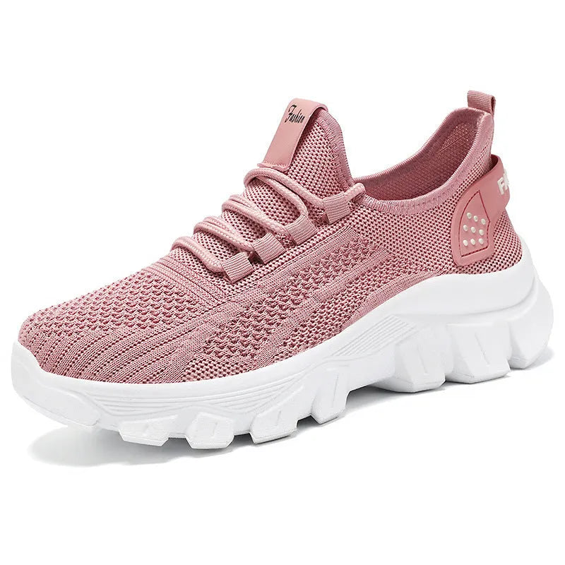 Women's white flyknit running sneaker with thick PVC sole and lace-up front