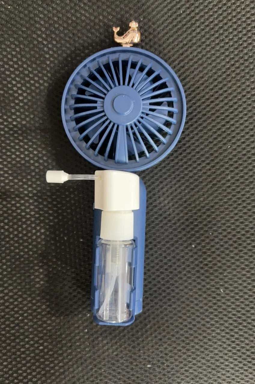 Plastic USB rechargeable personal nozzle fan in apricot colour on a desk