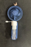 Plastic USB rechargeable personal nozzle fan in apricot colour on a desk