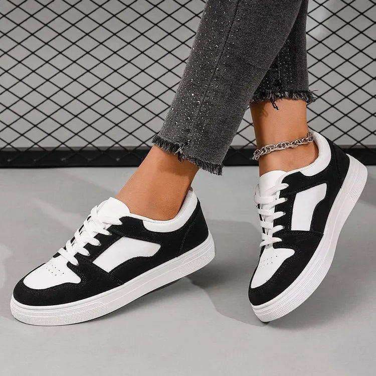 Black women's casual sports shoes with round toe, lace-up front, and flat rubber sole.