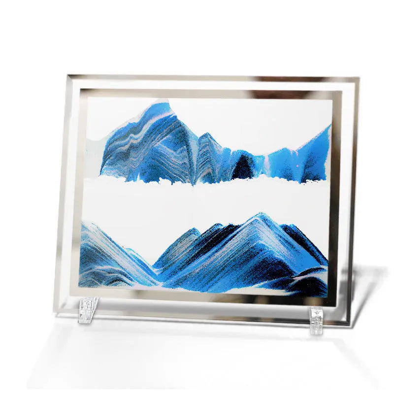 Modern geometric glass quicksand painting ornament with landscape scene on a shelf.