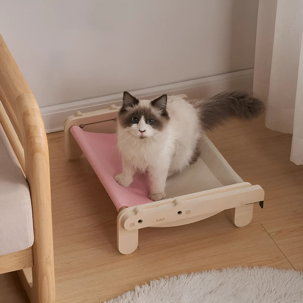 Solid wood pet bed for cats with removable washable cover in black and white plaid pattern on floor