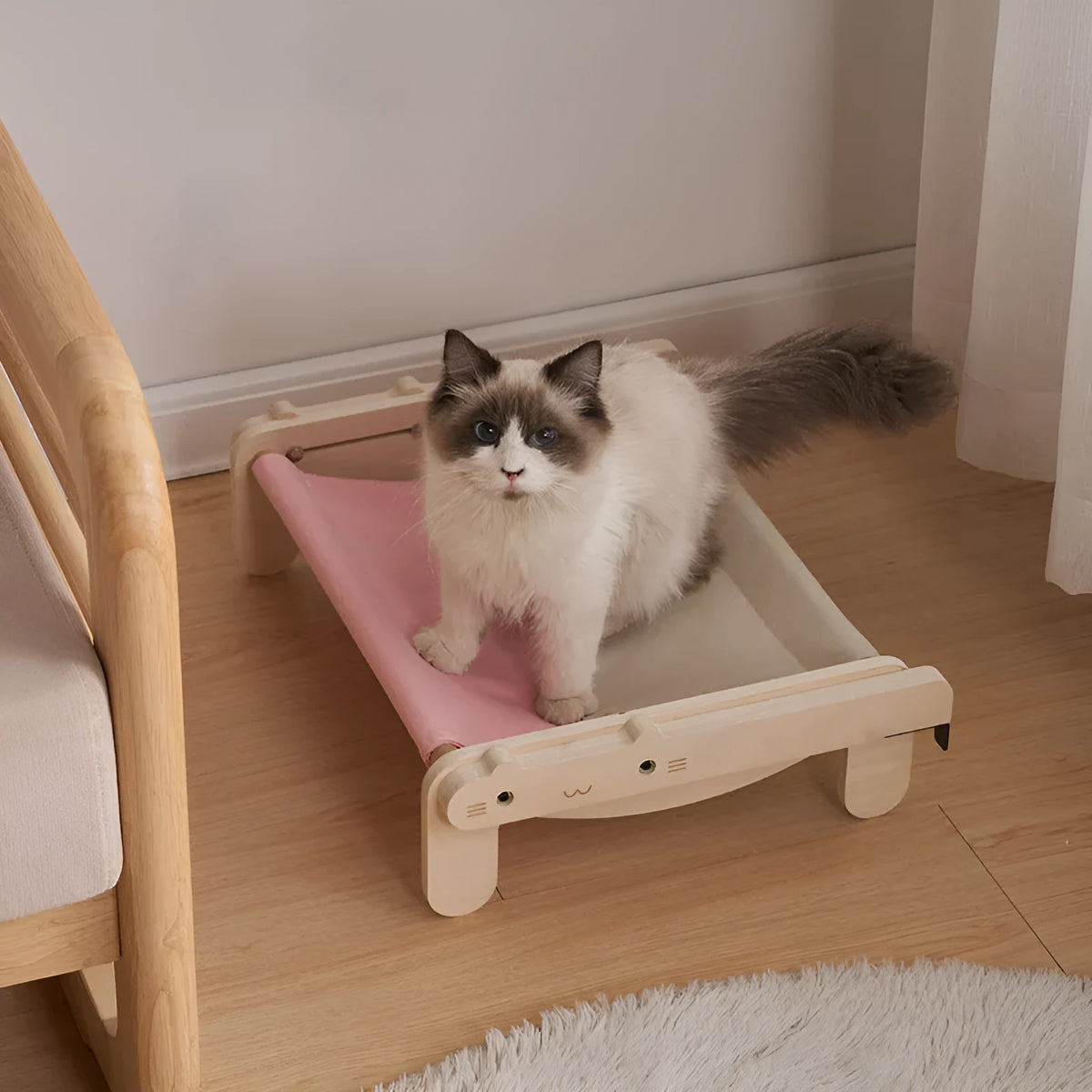 Solid wood pet bed for cats with removable washable cover in black and white plaid pattern on floor