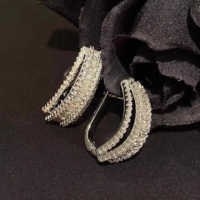 Geometric stud earrings with zircon stones in white gold colour on copper base