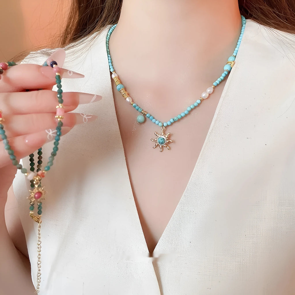 Freshwater pearl necklace with stone sun pendant in blue-sun colour option, court style geometric design