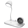 White three-in-one desk lamp with integrated digital clock and wireless charging pad on black desktop