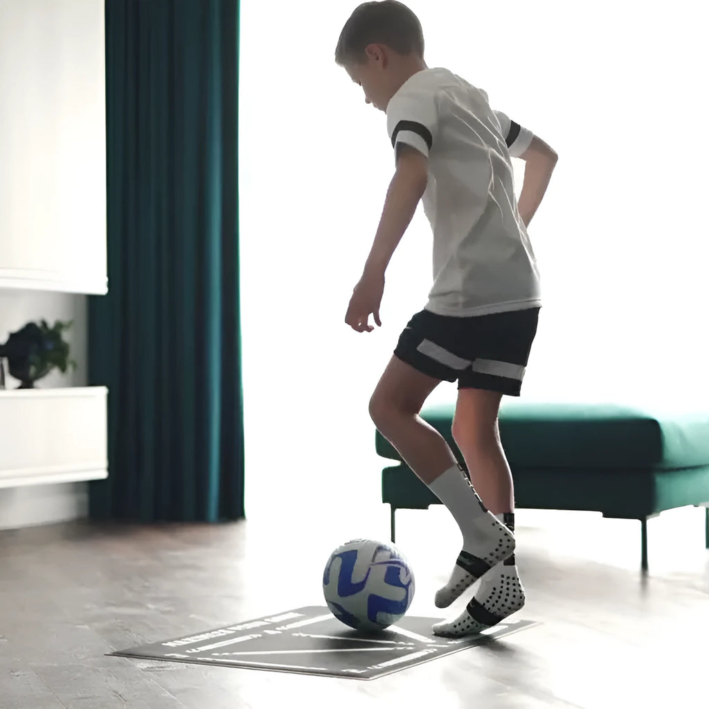 Black rectangular football training mat measuring 60cm by 90cm with a non-slip base for practice drills.