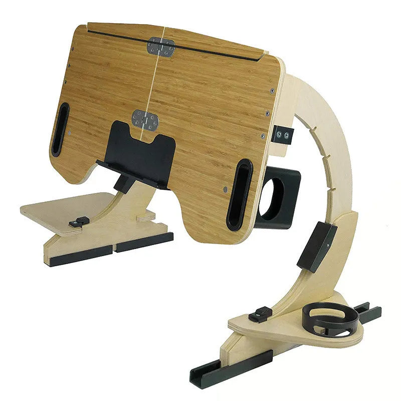 Wooden folding laptop table on a bed with adjustable angle, shown in white maple finish.