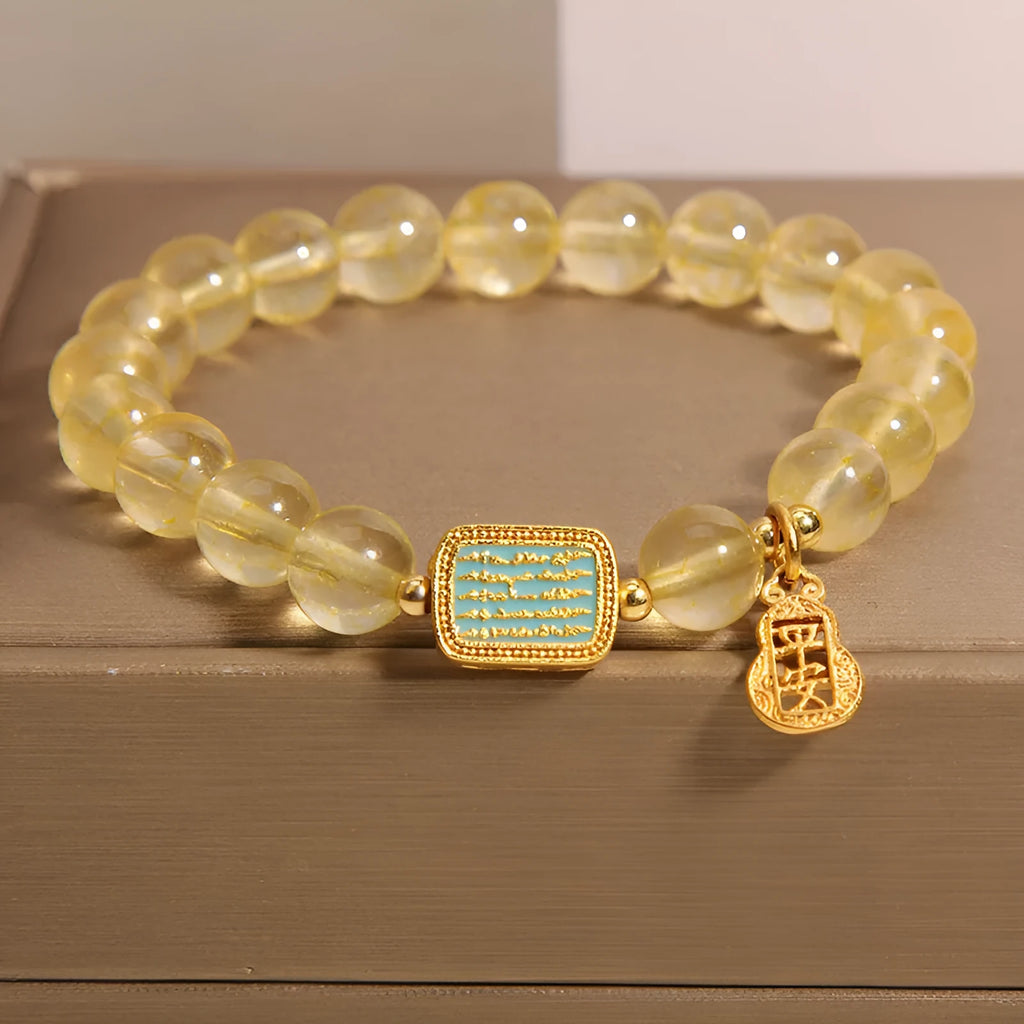 Women's yellow citrine crystal bracelet with rhinestone accents on wrist