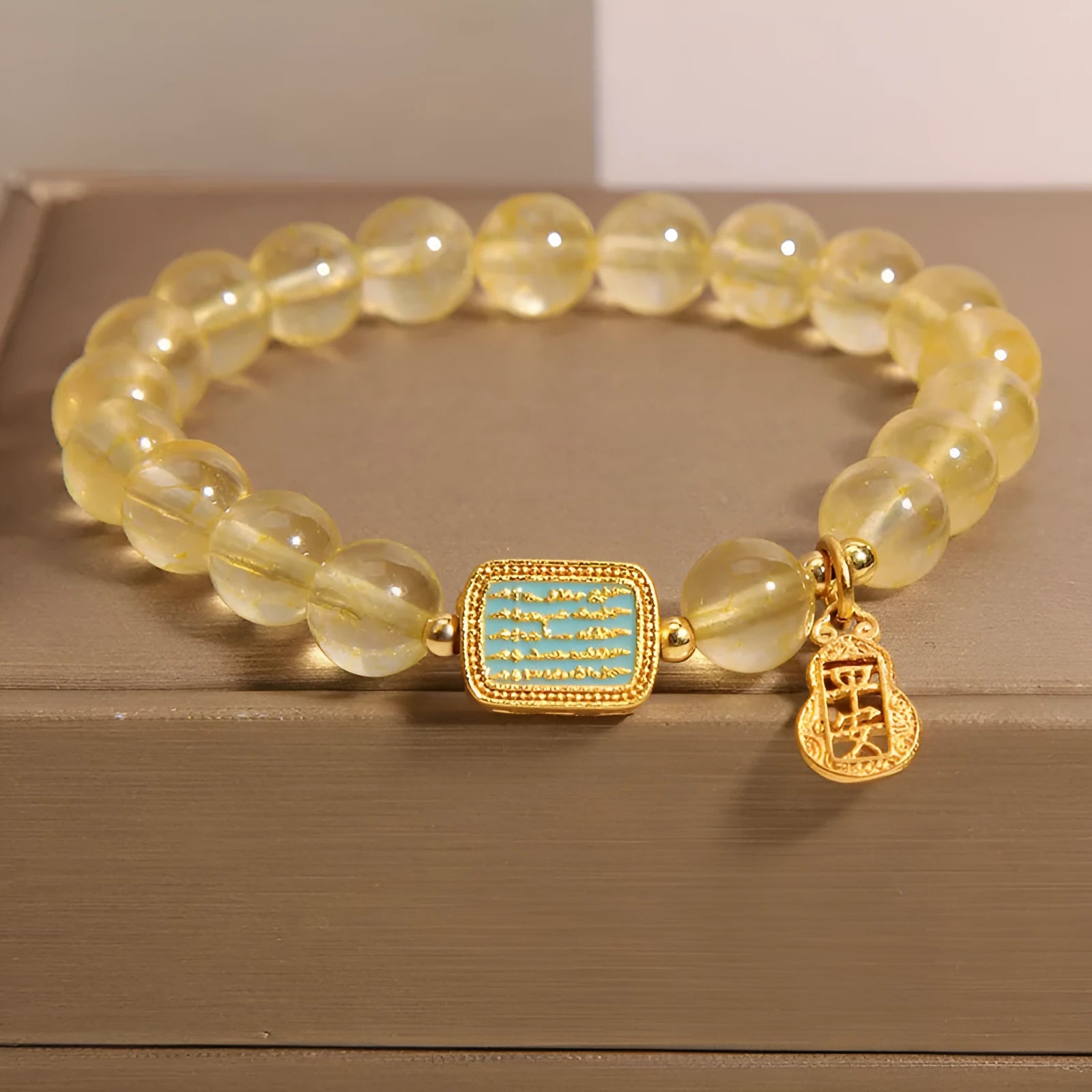 Women's yellow citrine crystal bracelet with rhinestone accents on wrist