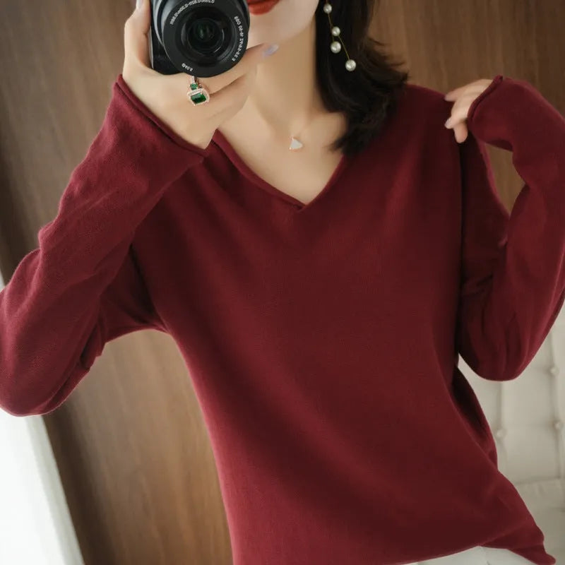 Women's V-neck long sleeve knitwear top in turmeric colour on a hanger
