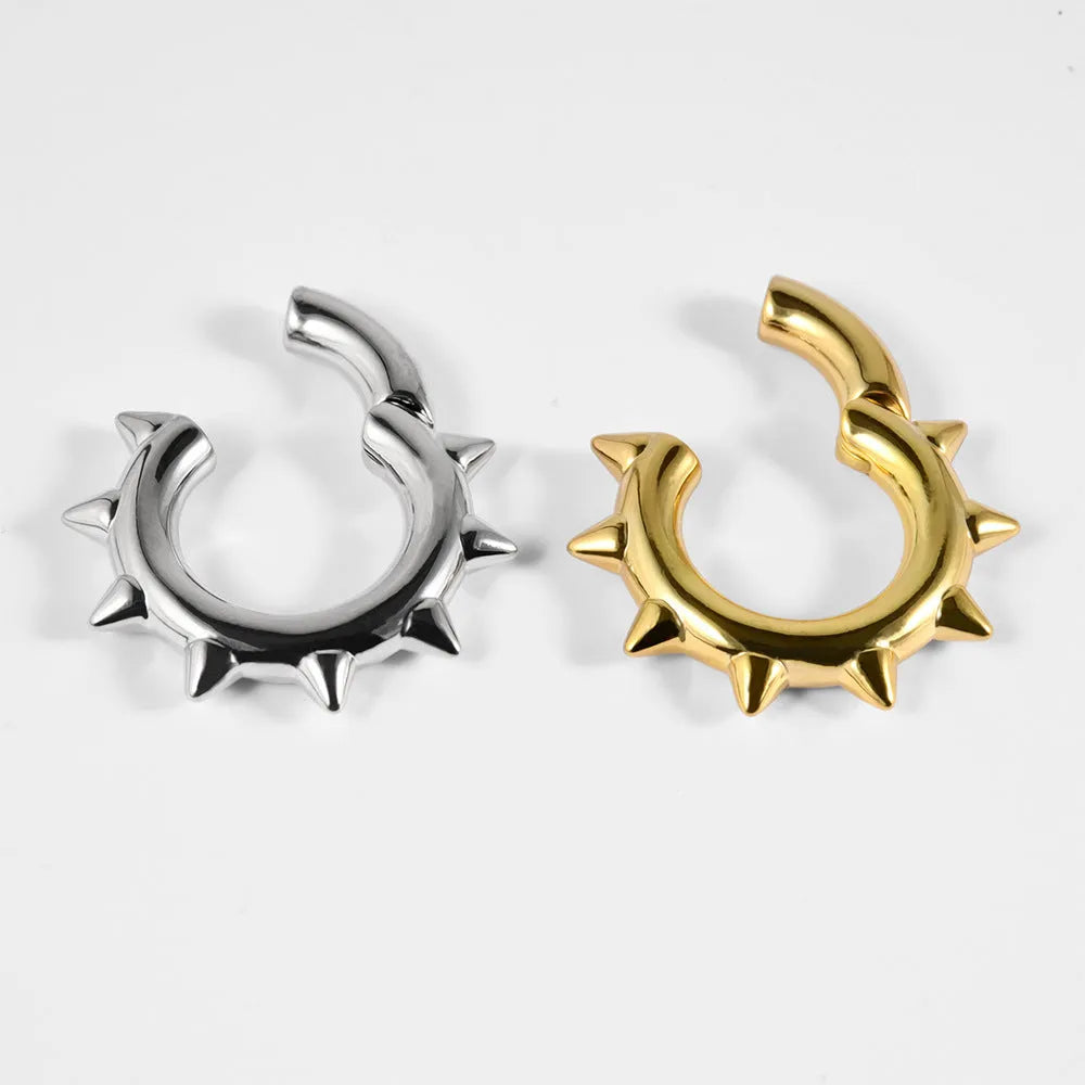 A pair of geometric sharp cone round ear tunnel stretchers with a magnetic closure, made from copper.