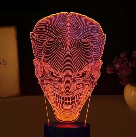 3D acrylic LED table lamp with USB cable and remote control on a desk