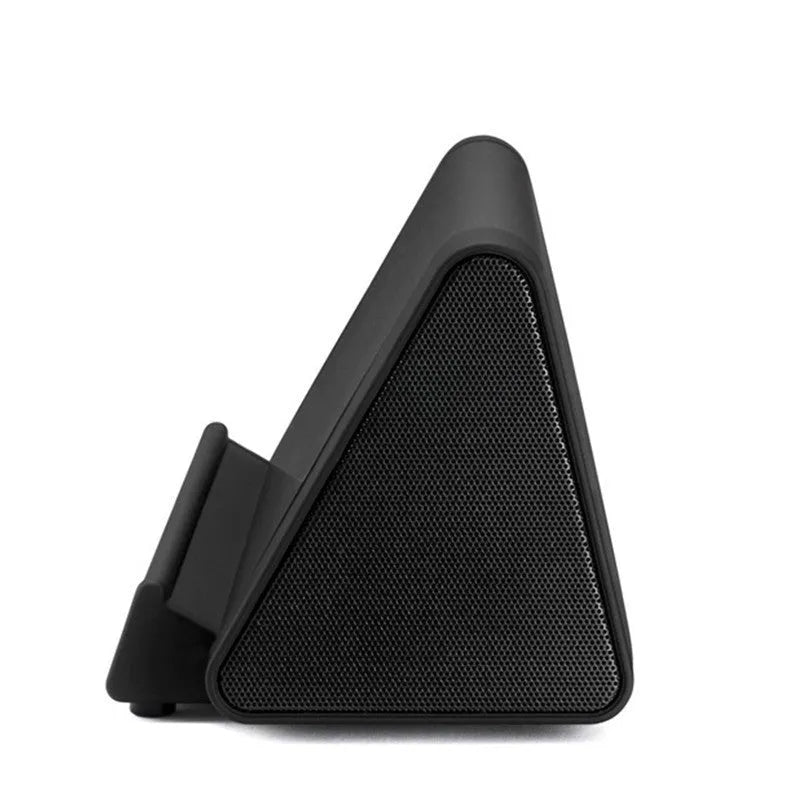 Small black and white wireless Bluetooth mini speaker with built-in charging cable.