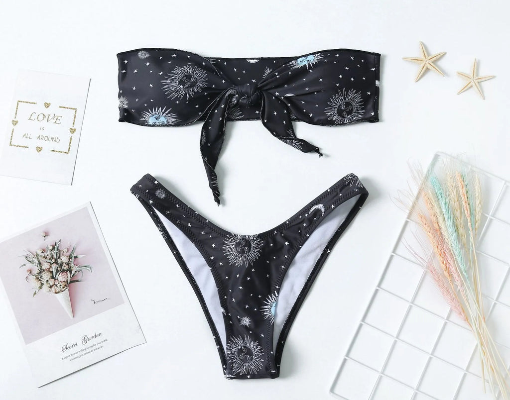 Black printed one-piece swimsuit with a backless design for women.