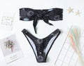 Black printed one-piece swimsuit with a backless design for women.
