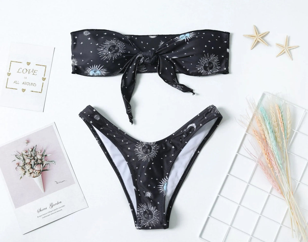 Black printed one-piece swimsuit with a backless design for women.