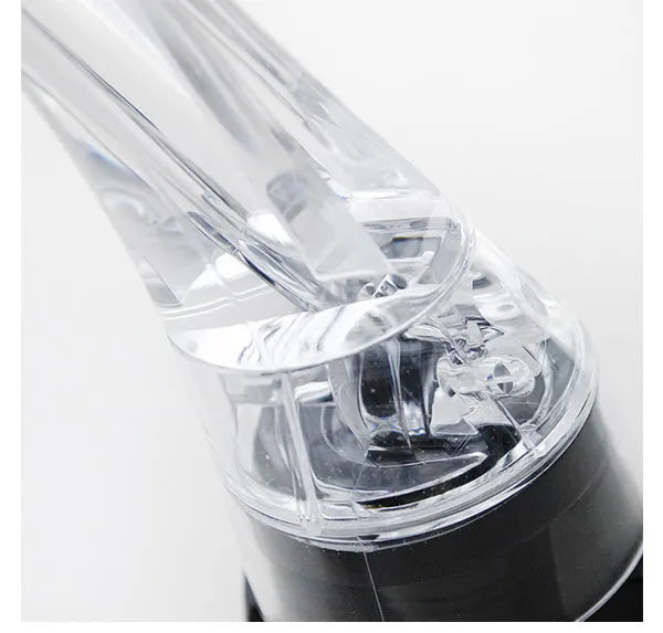Clear acrylic wine aerator with stainless steel filter measuring 16x4.2cm pouring red wine into a glass