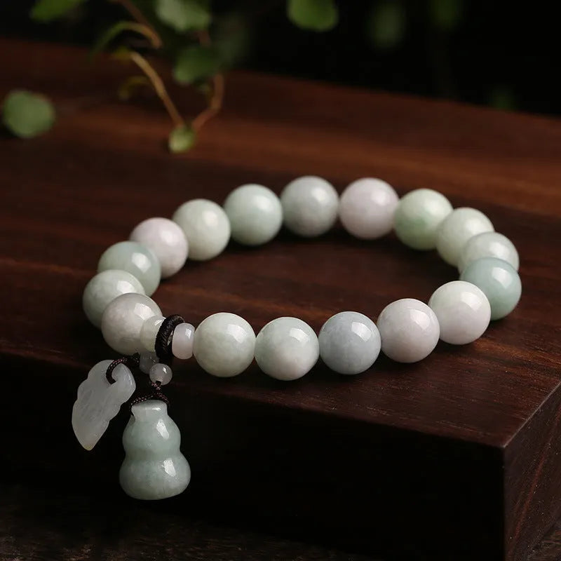 Green jade geometric bracelet with hanging Maitreya Buddha pendant on wrist