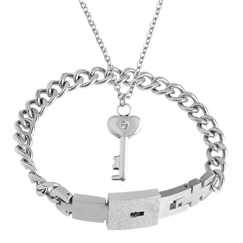 Interlocking peach heart key necklace and bracelet set in titanium stainless steel, shown in steel, black, and golden colour options