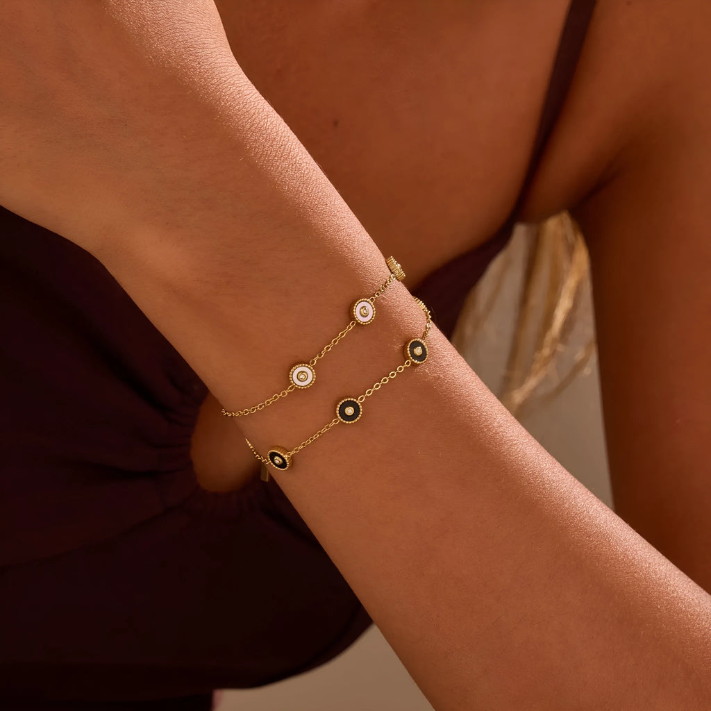 Stainless steel bracelet with 18K gold electroplating and geometric fritillary design, shown with matching necklace