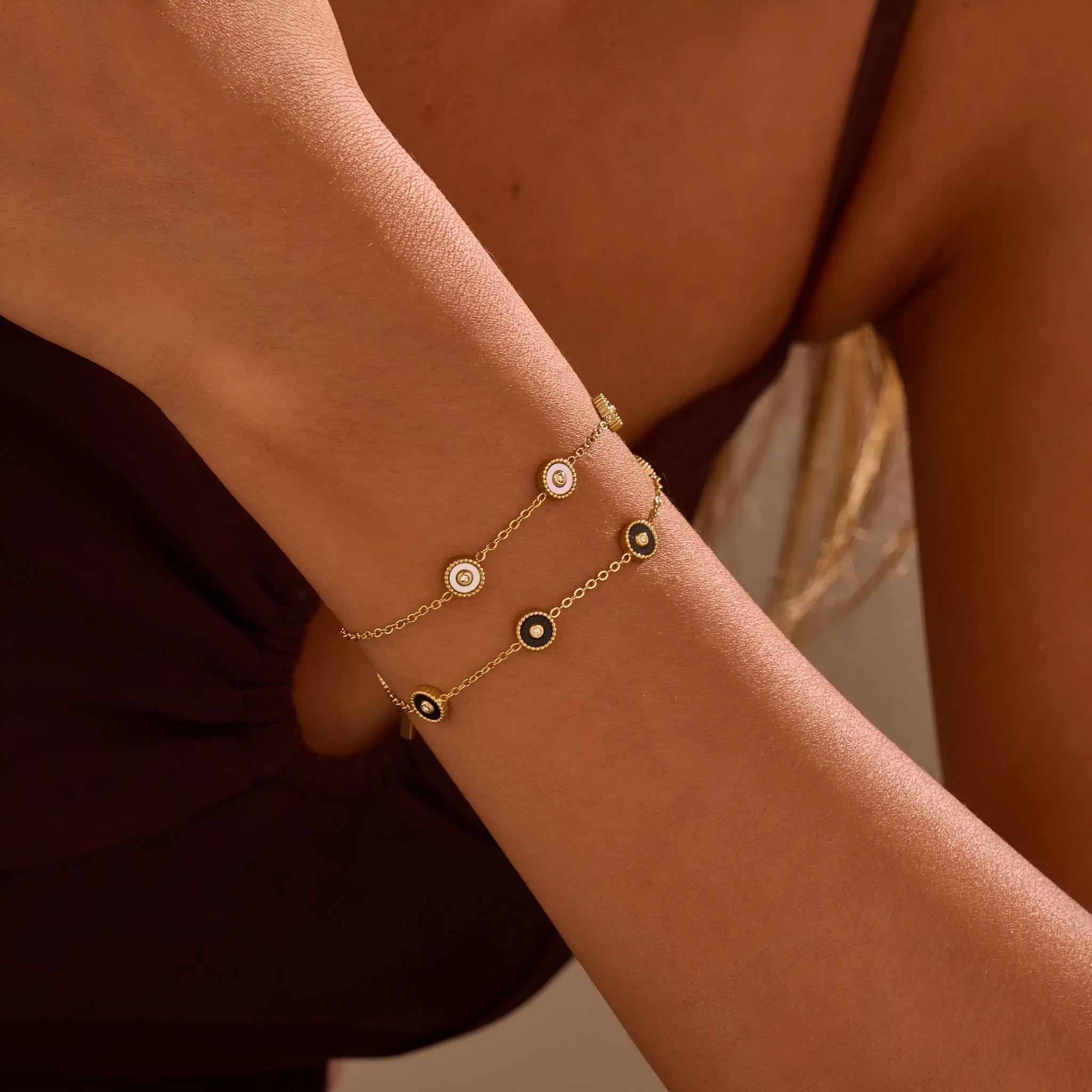 Stainless steel bracelet with 18K gold electroplating and geometric fritillary design, shown with matching necklace