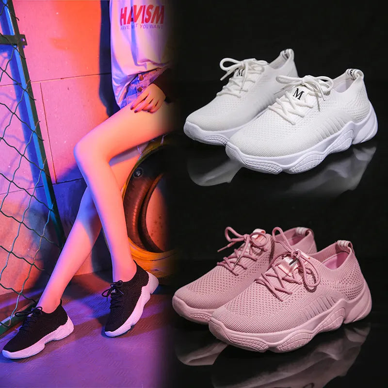 White women's low-top woven sports shoes with thick rubber sole and front strap closure.