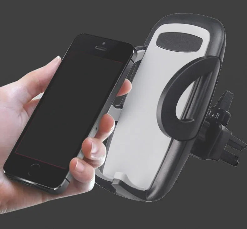 Black plastic car mobile phone holder mounted on air conditioning vent holding smartphone