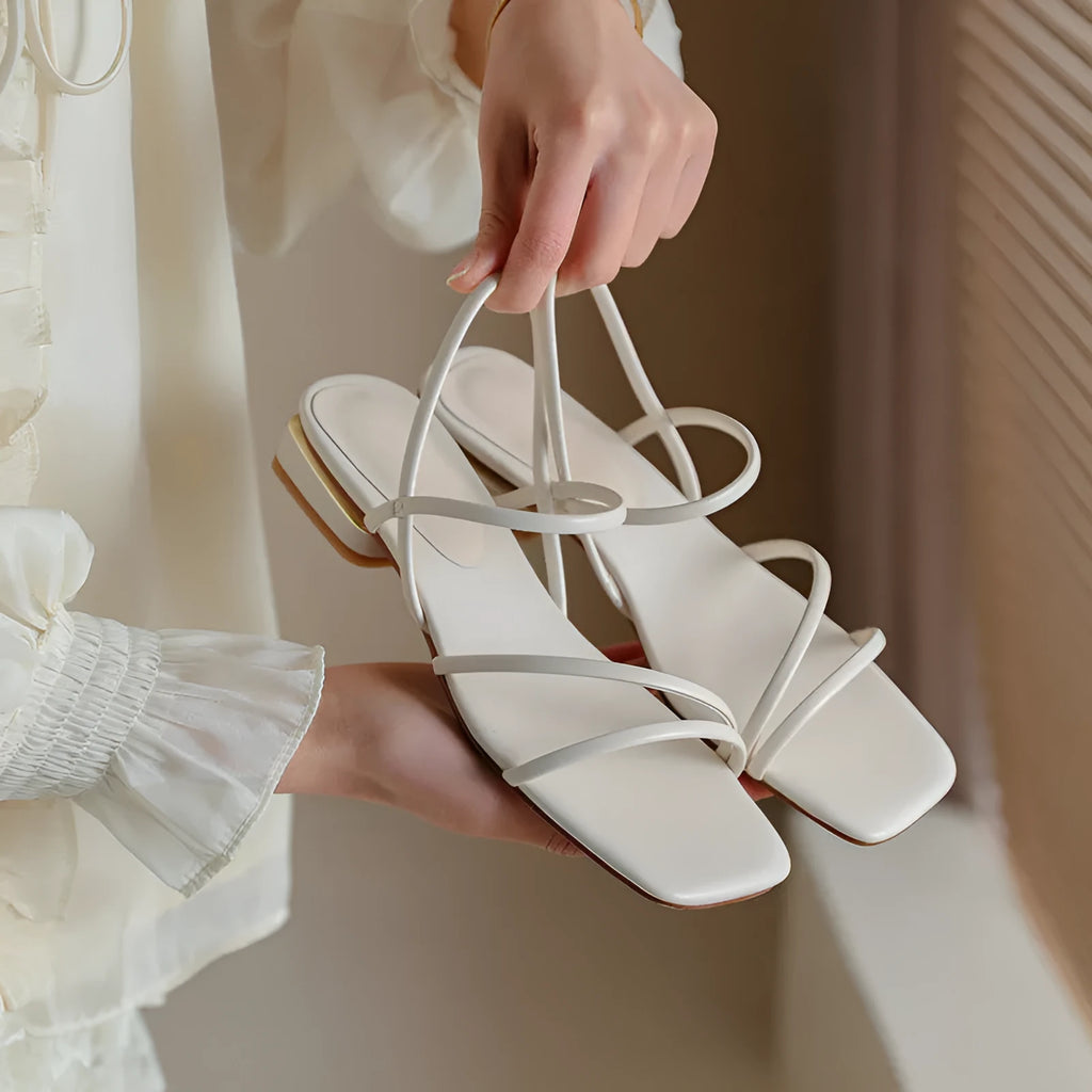 Women's flat strap open-toe Roman sandals in microfiber with a square toe, shown in a neutral colour.