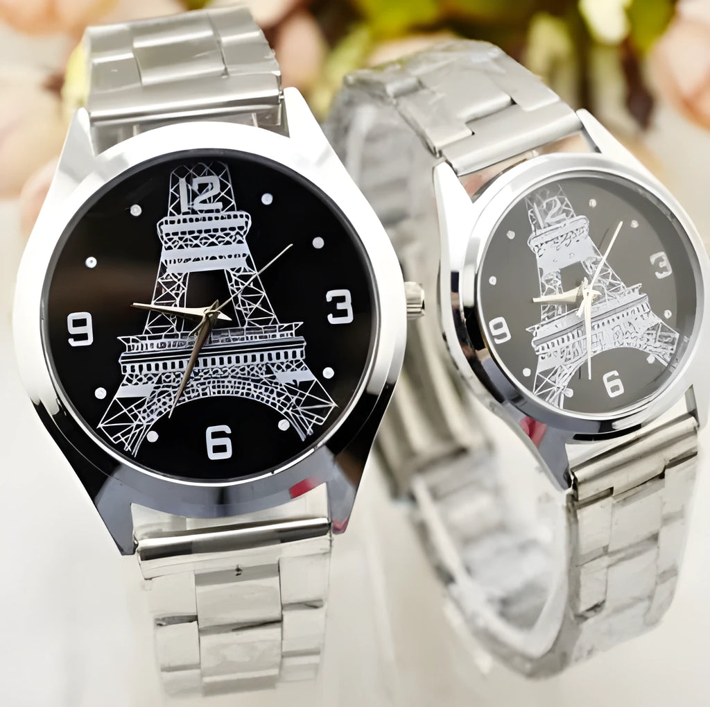 Silver Eiffel Tower wrist watch with leather strap on a wrist, showing detailed dial design.