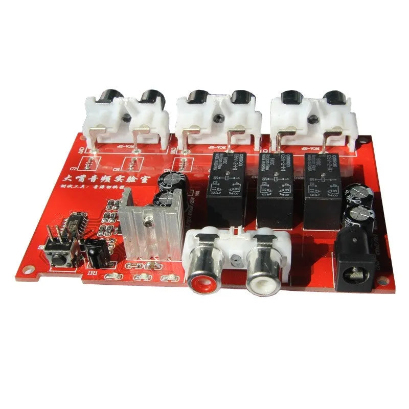 Silver aluminium audio source selector switch box with front button and infrared remote control.